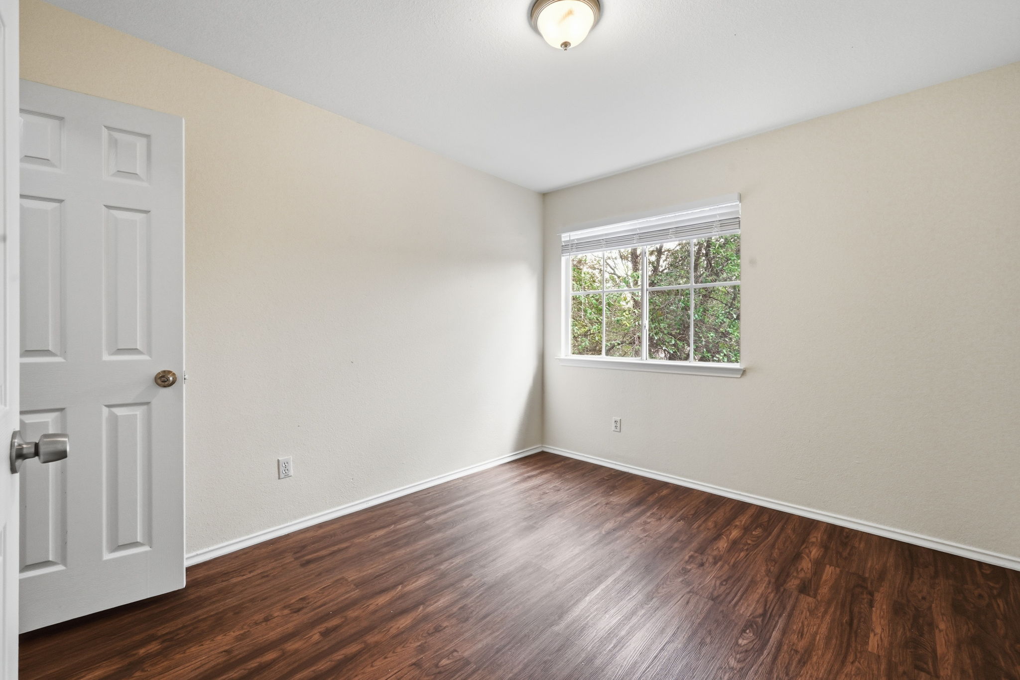 11145 Franklins Tale Loop Austin, TX 78748 - Photo 18 of 31 an empty room with wooden floor and windows