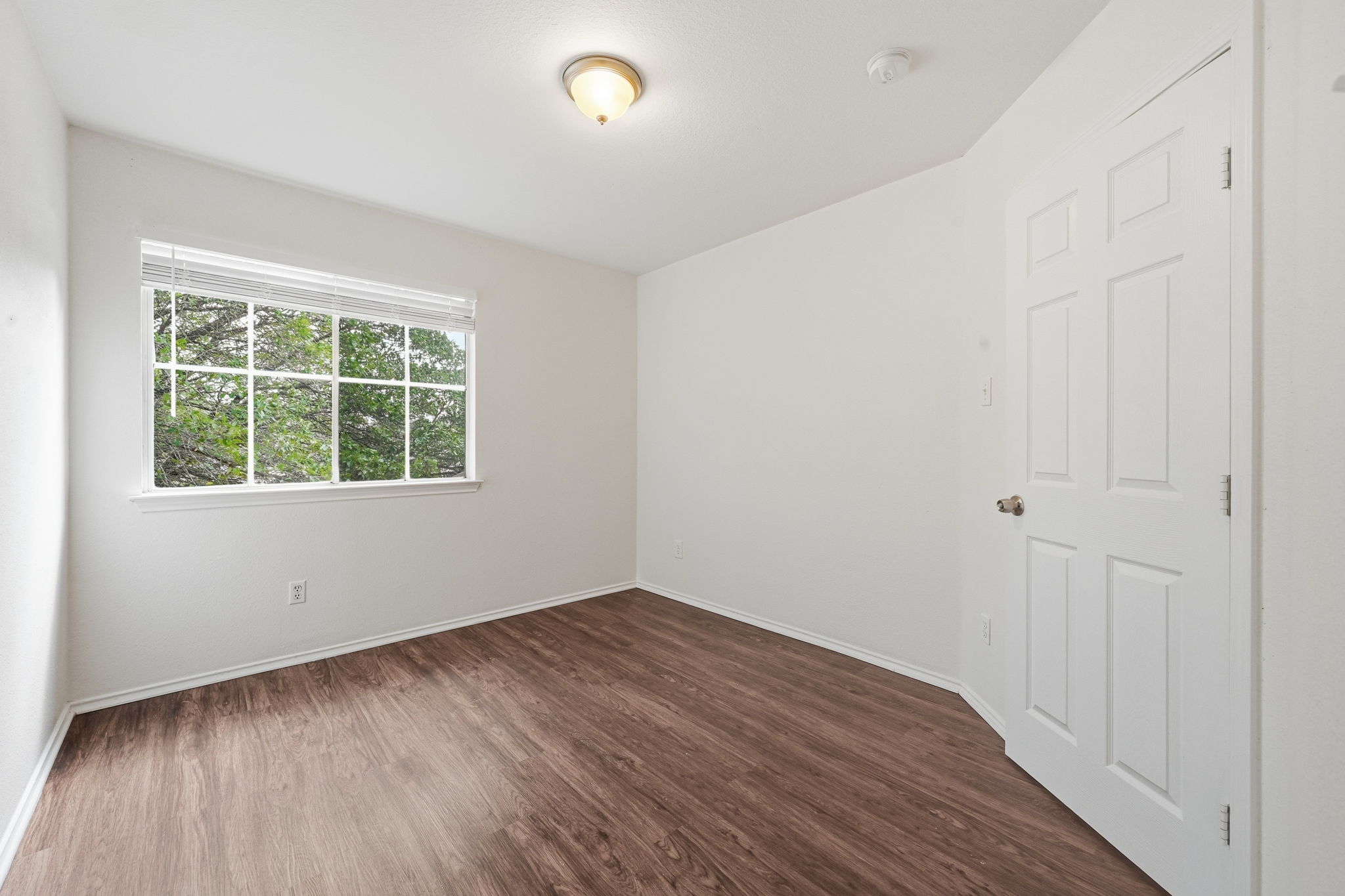 11145 Franklins Tale Loop Austin, TX 78748 - Photo 19 of 31 an empty room with wooden floor and windows
