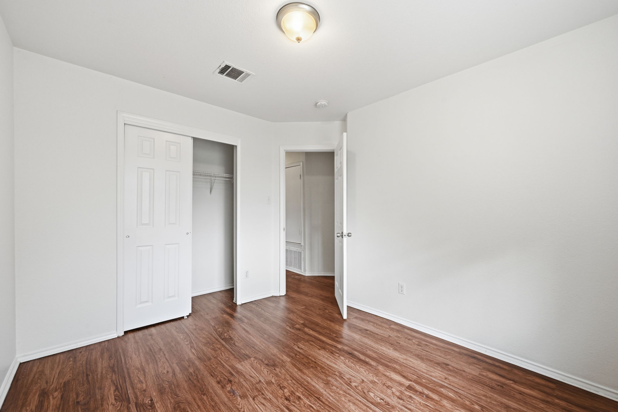 11145 Franklins Tale Loop Austin, TX 78748 - Photo 21 of 31 a view of an empty room with wooden floor