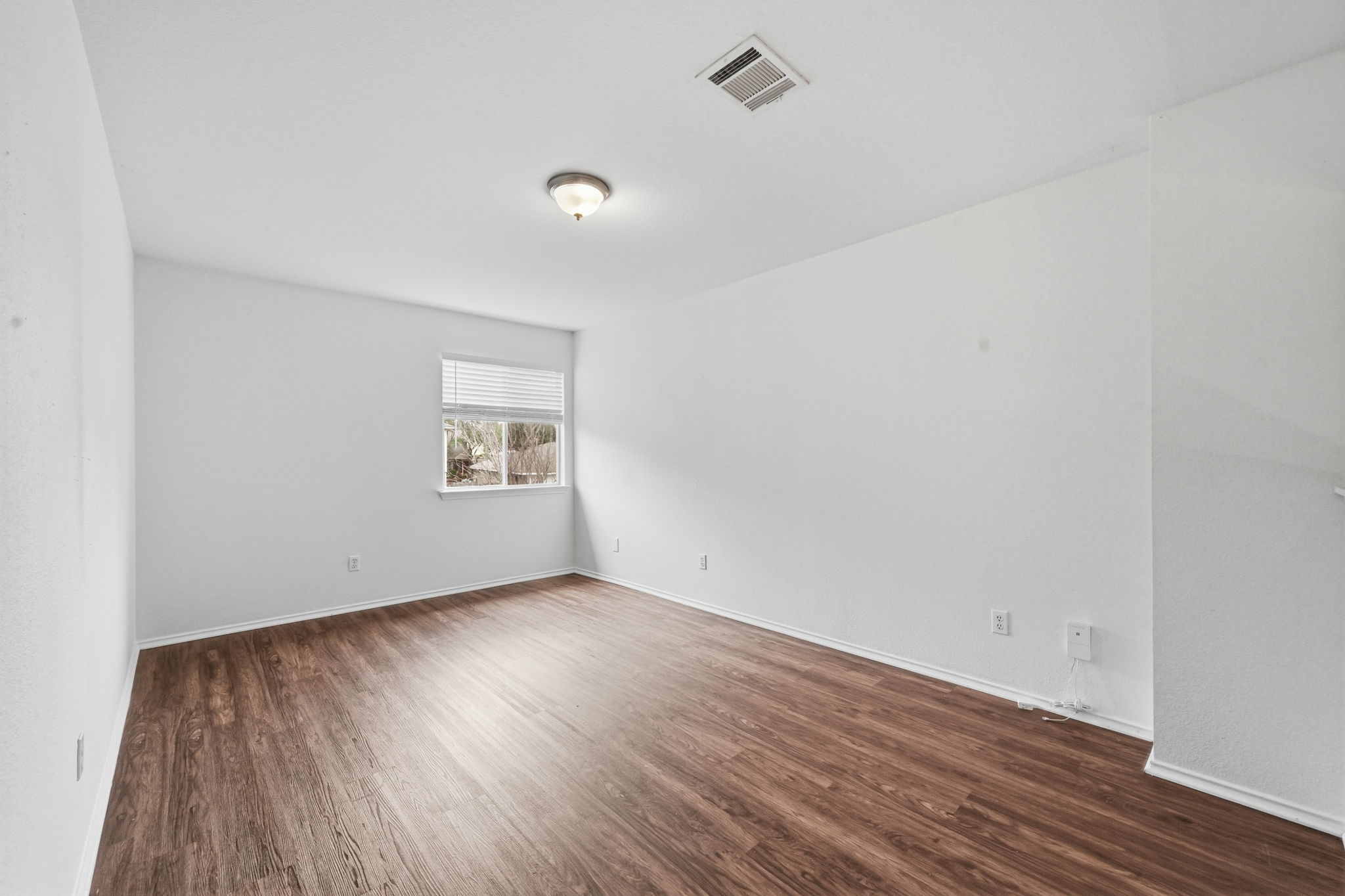 11145 Franklins Tale Loop Austin, TX 78748 - Photo 22 of 31 an empty room with wooden floor and windows