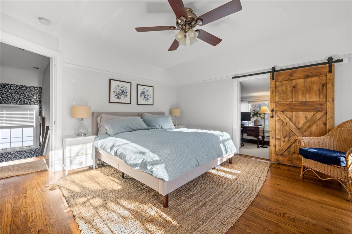 368 Woodland Road Highland Park, IL 60035 - Photo 14 of 29 a bedroom with a bed and wooden floor