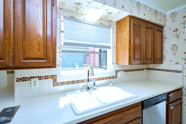 a kitchen with stainless steel appliances granite countertop a stove and a microwave
