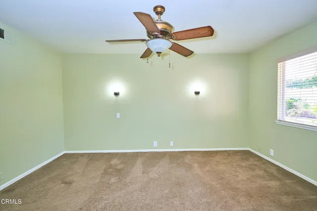 a bathroom with a granite countertop sink a toilet a mirror and shower