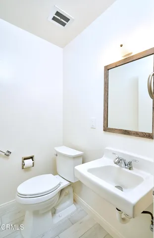 a view of a backyard with plants and brick house