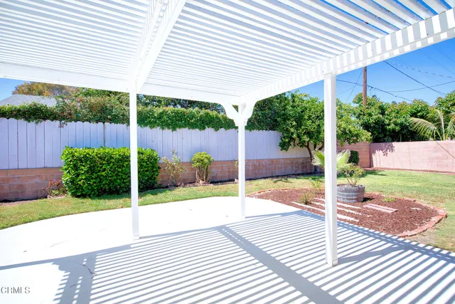 a view of a patio with table and chairs and potted plants