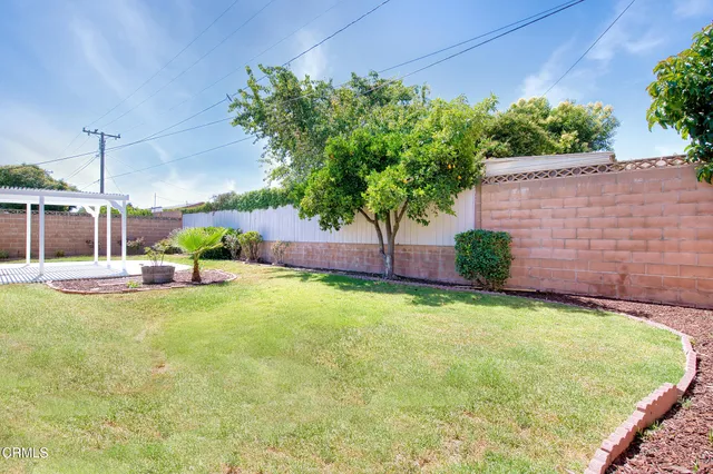 a view of a patio with table and chairs and potted plants