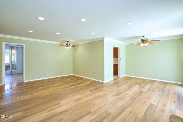 a view of an empty room with wooden floor