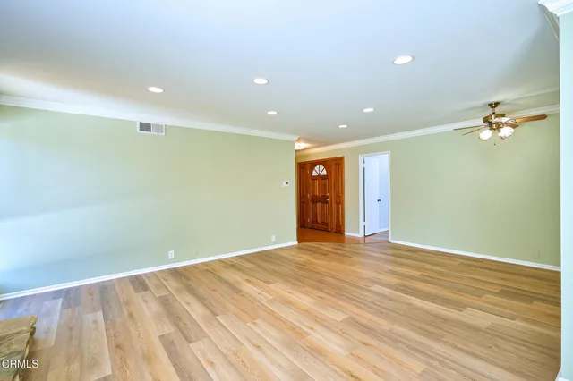 a view of a room with wooden floor and windows