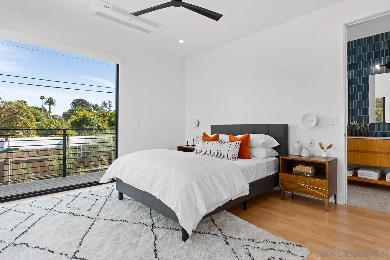 605 Cornish Drive Encinitas, CA 92024 - Photo 16 of 32 a bedroom with a large bed and a window