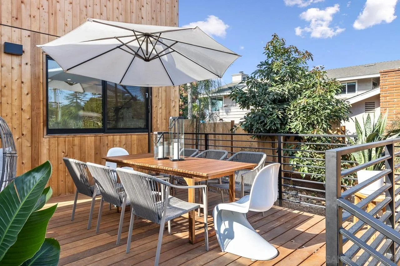 605 Cornish Drive Encinitas, CA 92024 - Photo 24 of 32 a patio with wooden floor a yard a table and chairs