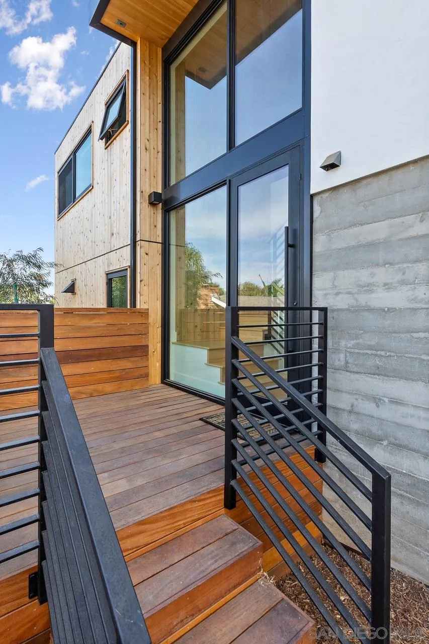 605 Cornish Drive Encinitas, CA 92024 - Photo 27 of 32 a view of a balcony with floor to ceiling windows with wooden floor
