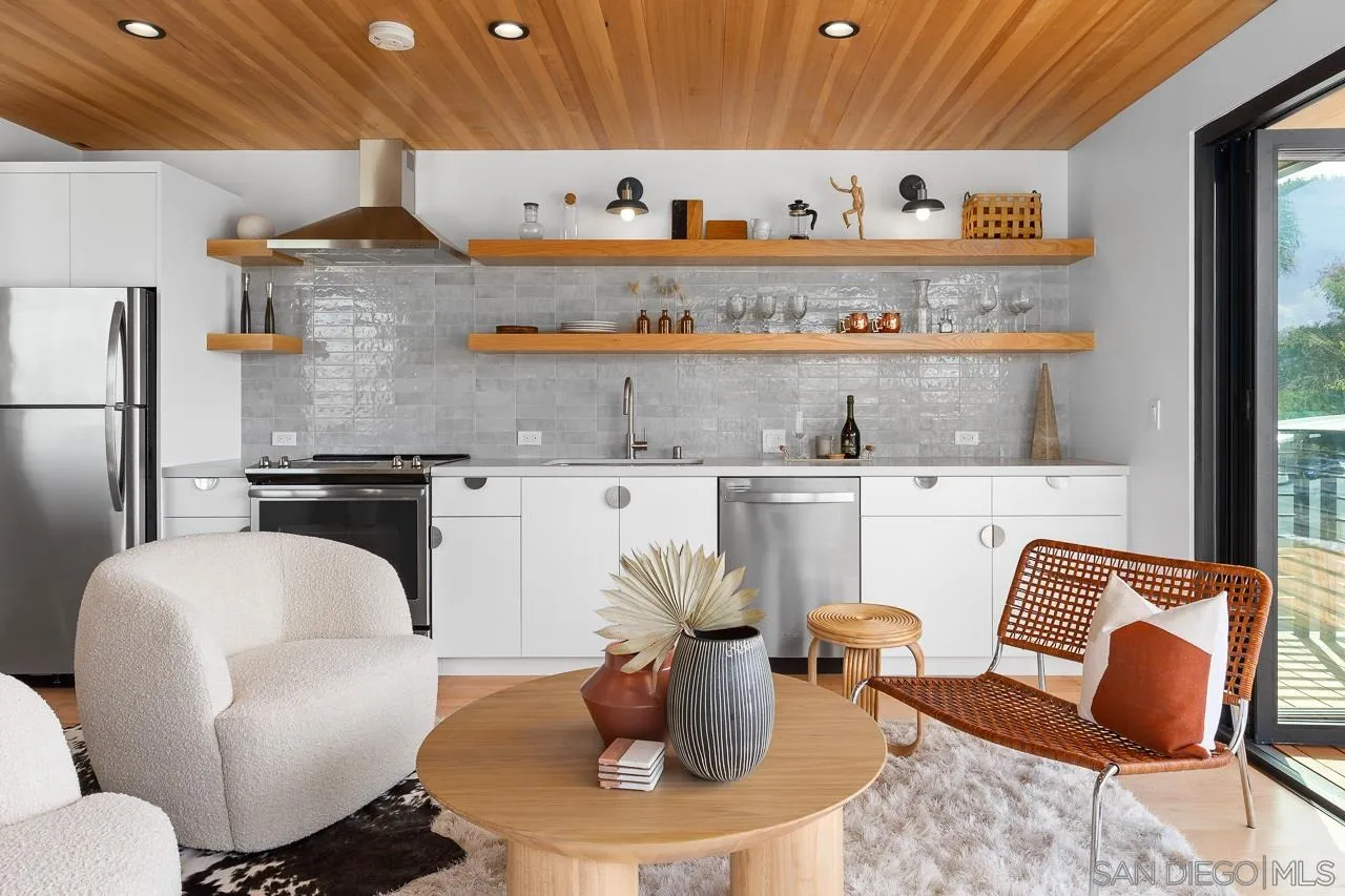 605 Cornish Drive Encinitas, CA 92024 - Photo 30 of 32 a living room with furniture kitchen view and a piano