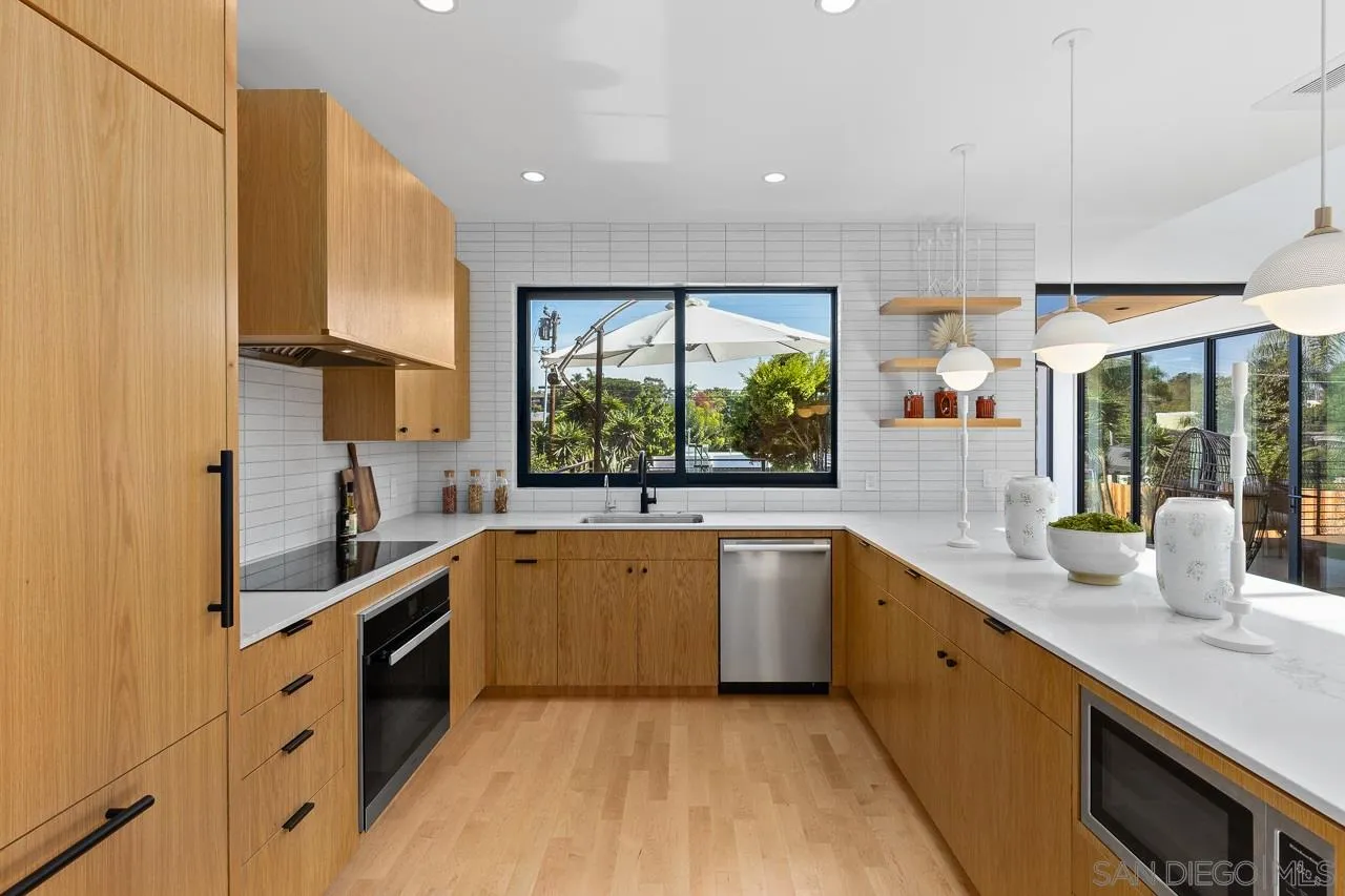 605 Cornish Drive Encinitas, CA 92024 - Photo 6 of 32 a large kitchen with stainless steel appliances granite countertop a sink and a stove