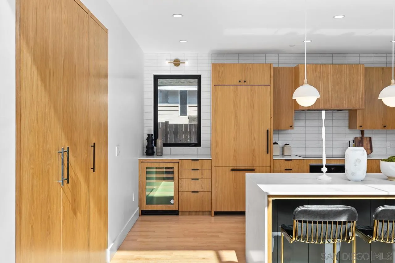 605 Cornish Drive Encinitas, CA 92024 - Photo 7 of 32 a kitchen with a sink and a refrigerator