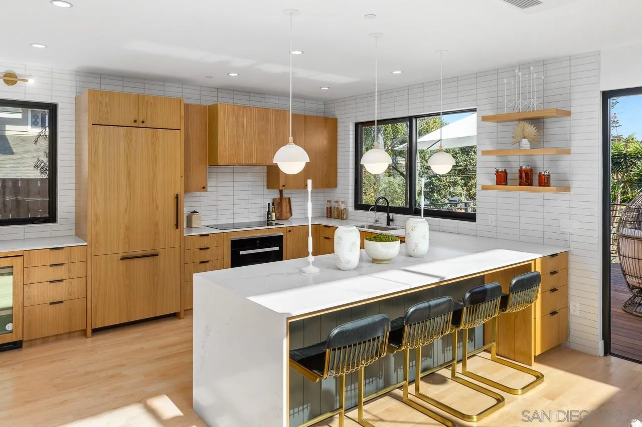 605 Cornish Drive Encinitas, CA 92024 - Photo 8 of 32 a kitchen with stainless steel appliances granite countertop a sink a stove and a refrigerator