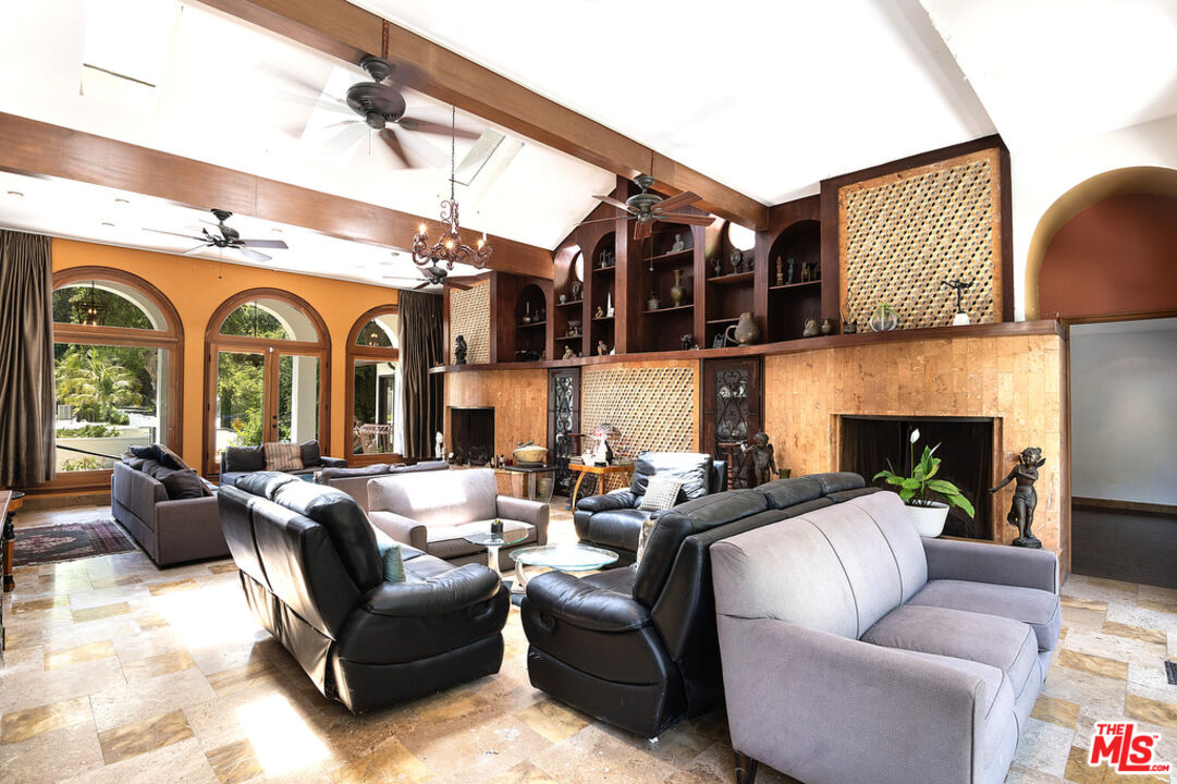 1260 Roscomare Road Los Angeles, CA 90077 - Photo 20 of 75 a living room with furniture fireplace and a flat screen tv