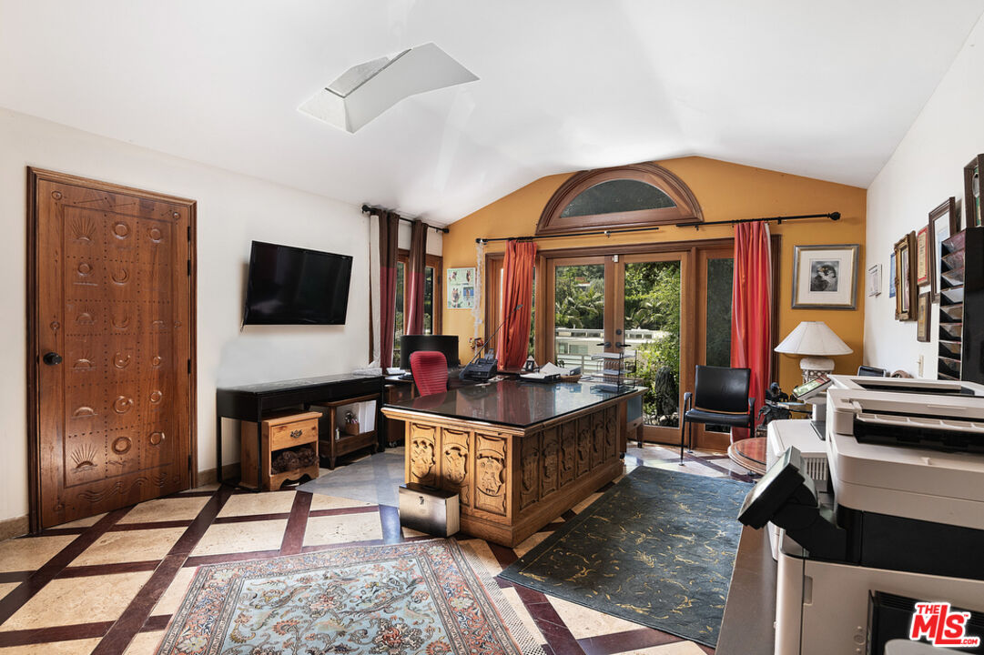 1260 Roscomare Road Los Angeles, CA 90077 - Photo 21 of 75 a living room with furniture and a flat screen tv