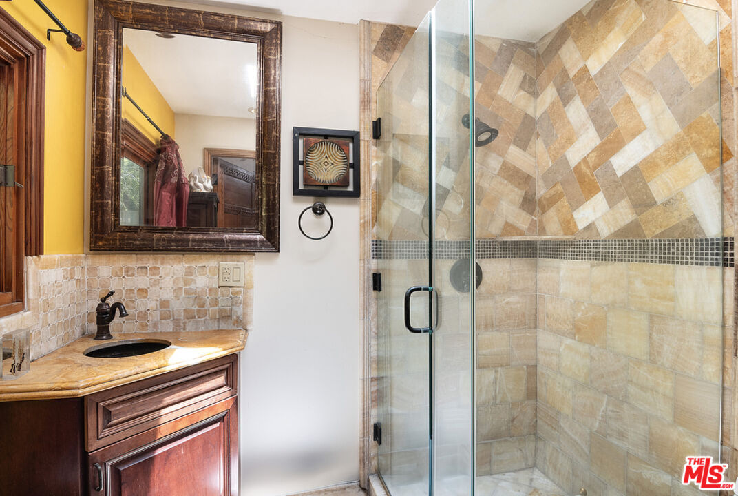 1260 Roscomare Road Los Angeles, CA 90077 - Photo 22 of 75 a bathroom with a sink and mirror with shower