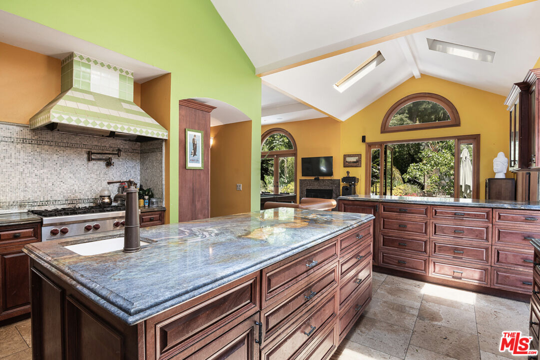 1260 Roscomare Road Los Angeles, CA 90077 - Photo 24 of 75 a kitchen with stainless steel appliances granite countertop a stove and a sink