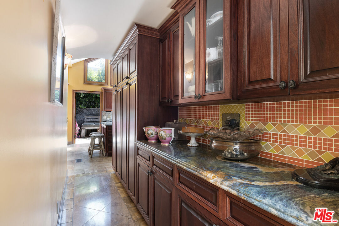 1260 Roscomare Road Los Angeles, CA 90077 - Photo 26 of 75 a kitchen with stainless steel appliances granite countertop a sink stove and cabinets