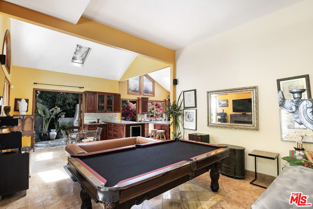 1260 Roscomare Road Los Angeles, CA 90077 - Photo 30 of 75 a living room with furniture pool table and a large window