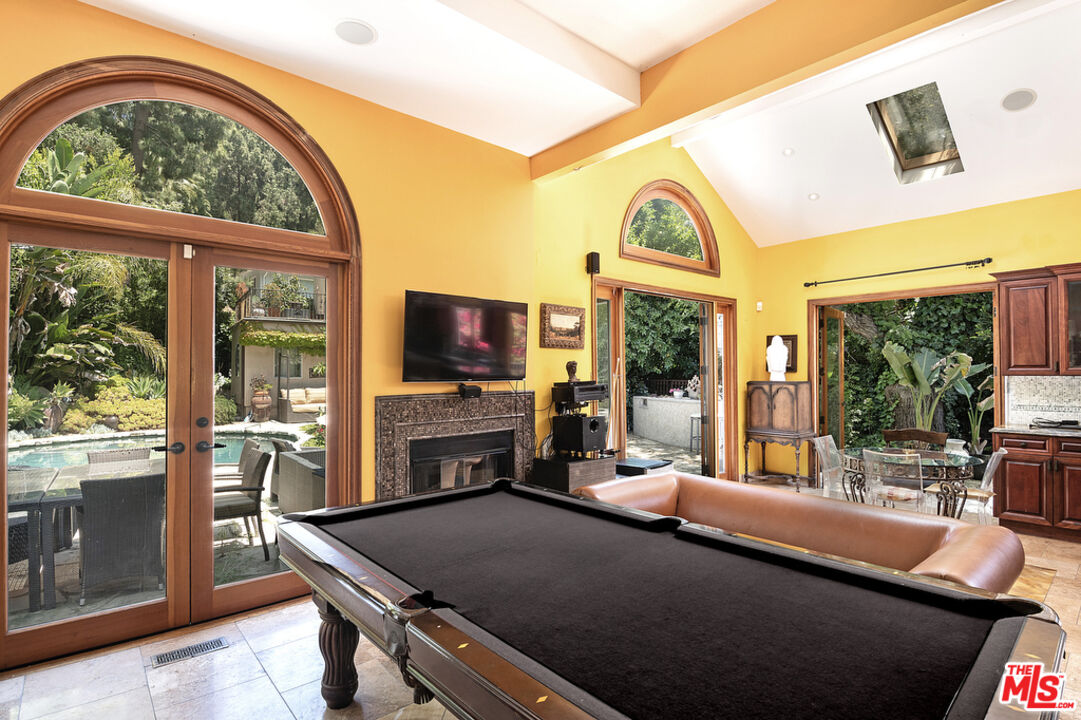 1260 Roscomare Road Los Angeles, CA 90077 - Photo 31 of 75 a living room with fireplace furniture and a flat screen tv