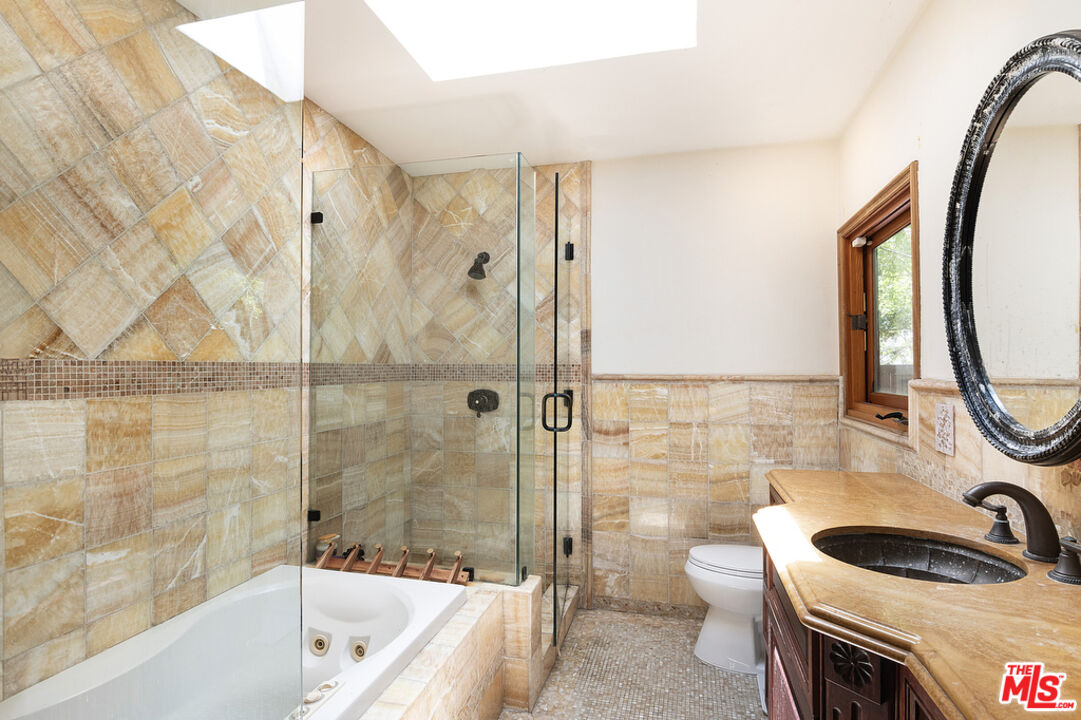 1260 Roscomare Road Los Angeles, CA 90077 - Photo 43 of 75 a bathroom with a sink a toilet a mirror and shower