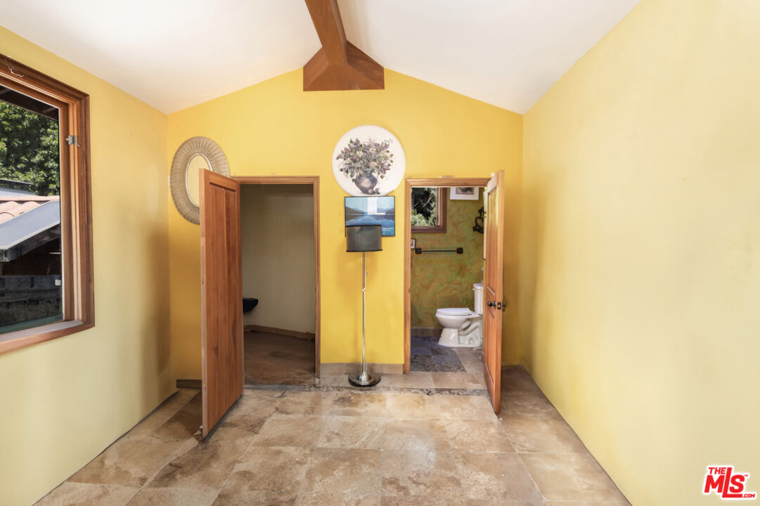 1260 Roscomare Road Los Angeles, CA 90077 - Photo 48 of 75 a view of a bathroom with a toilet and a shower