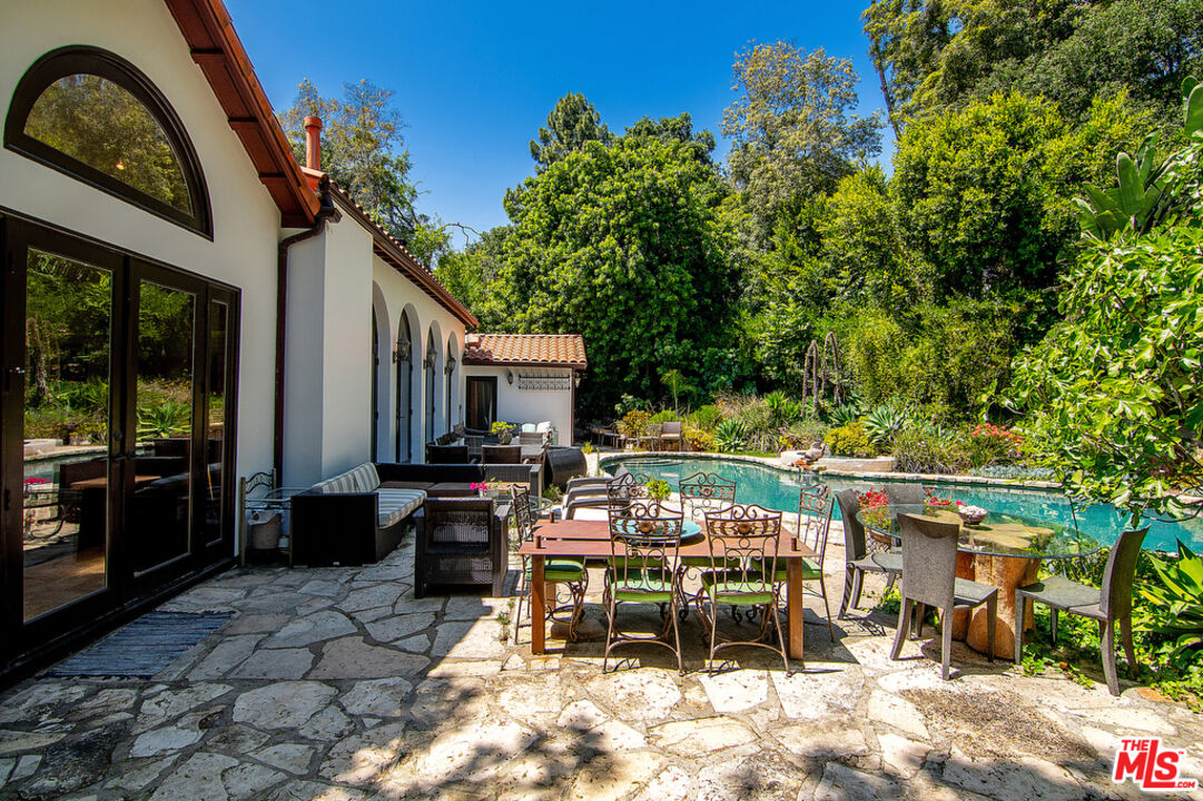 1260 Roscomare Road Los Angeles, CA 90077 - Photo 52 of 75 a view of a chairs and table in backyard of a house