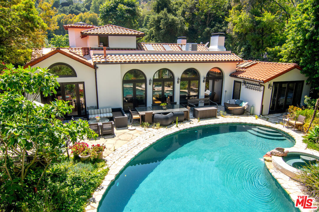 1260 Roscomare Road Los Angeles, CA 90077 - Photo 53 of 75 a view of a house with swimming pool and furniture