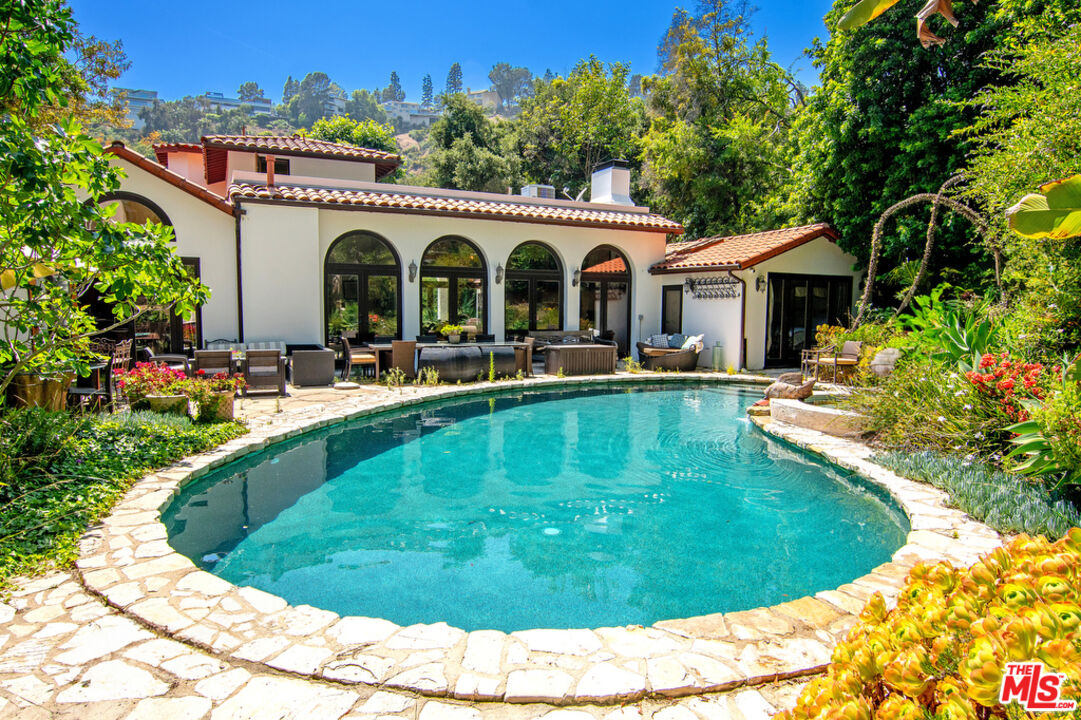 1260 Roscomare Road Los Angeles, CA 90077 - Photo 54 of 75 a view of a house with swimming pool and sitting area