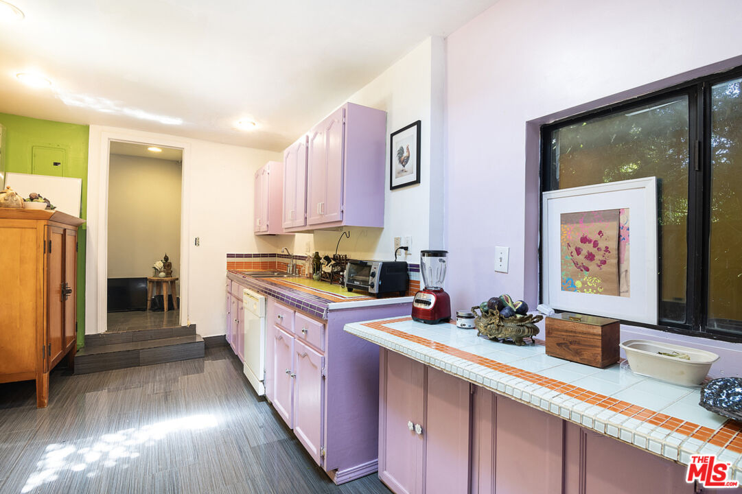 1260 Roscomare Road Los Angeles, CA 90077 - Photo 62 of 75 a kitchen with stainless steel appliances granite countertop a sink stove and cabinets