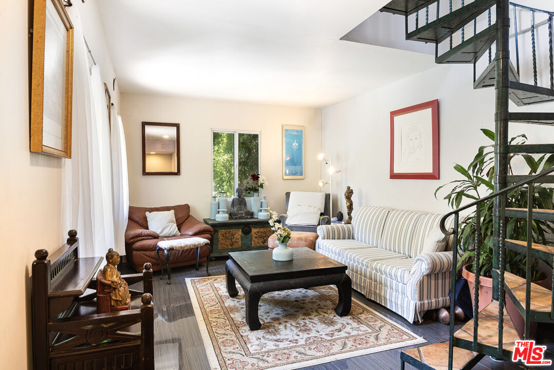 1260 Roscomare Road Los Angeles, CA 90077 - Photo 64 of 75 a living room with furniture a rug and a window