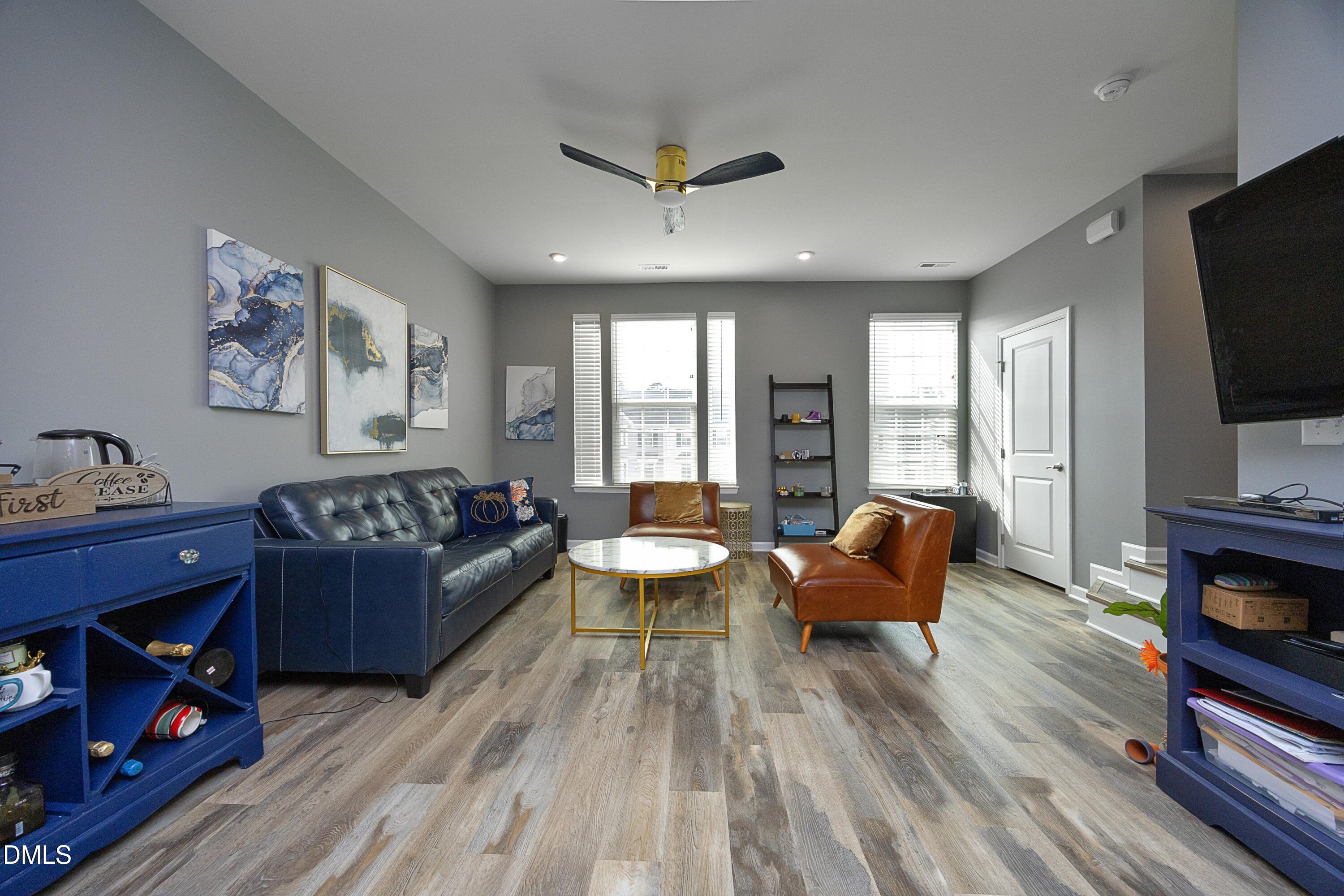 8716 Red Canyon Way Raleigh, NC 27616 - Photo 16 of 36 a living room with furniture and a flat screen tv
