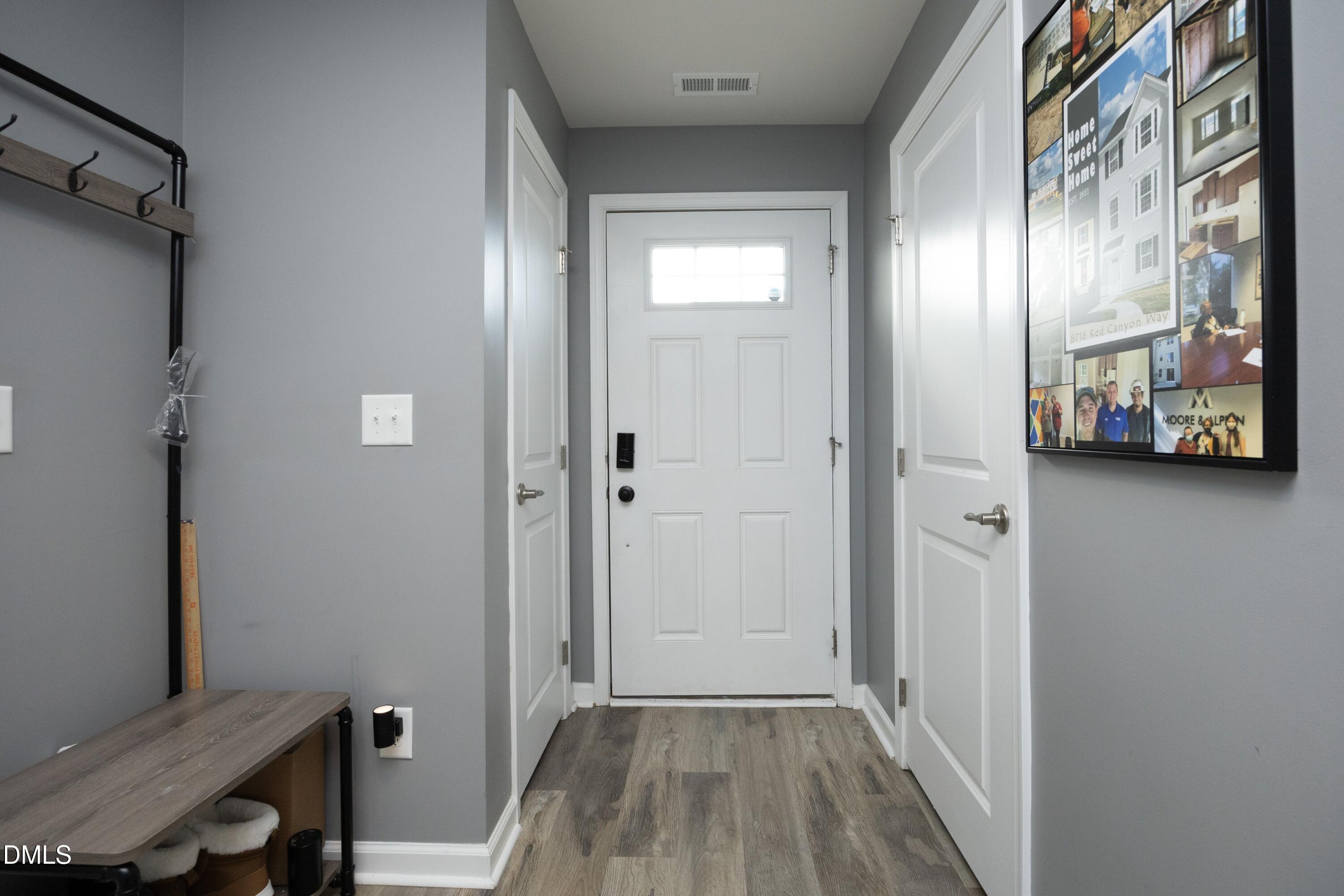 8716 Red Canyon Way Raleigh, NC 27616 - Photo 5 of 36 a view of a room with wooden floor and a bathroom