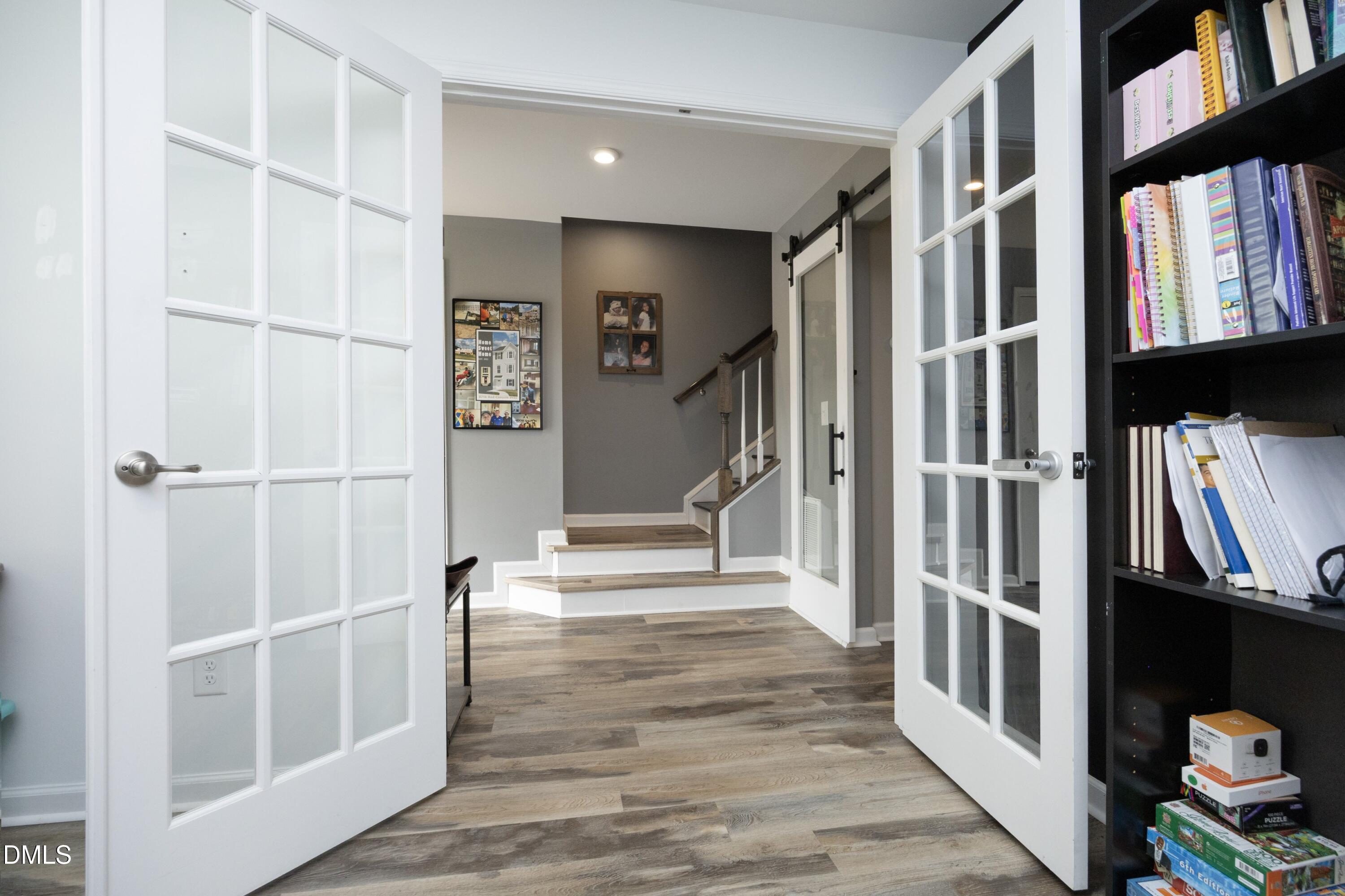 8716 Red Canyon Way Raleigh, NC 27616 - Photo 6 of 36 a view of an entryway with wooden floor and a front door