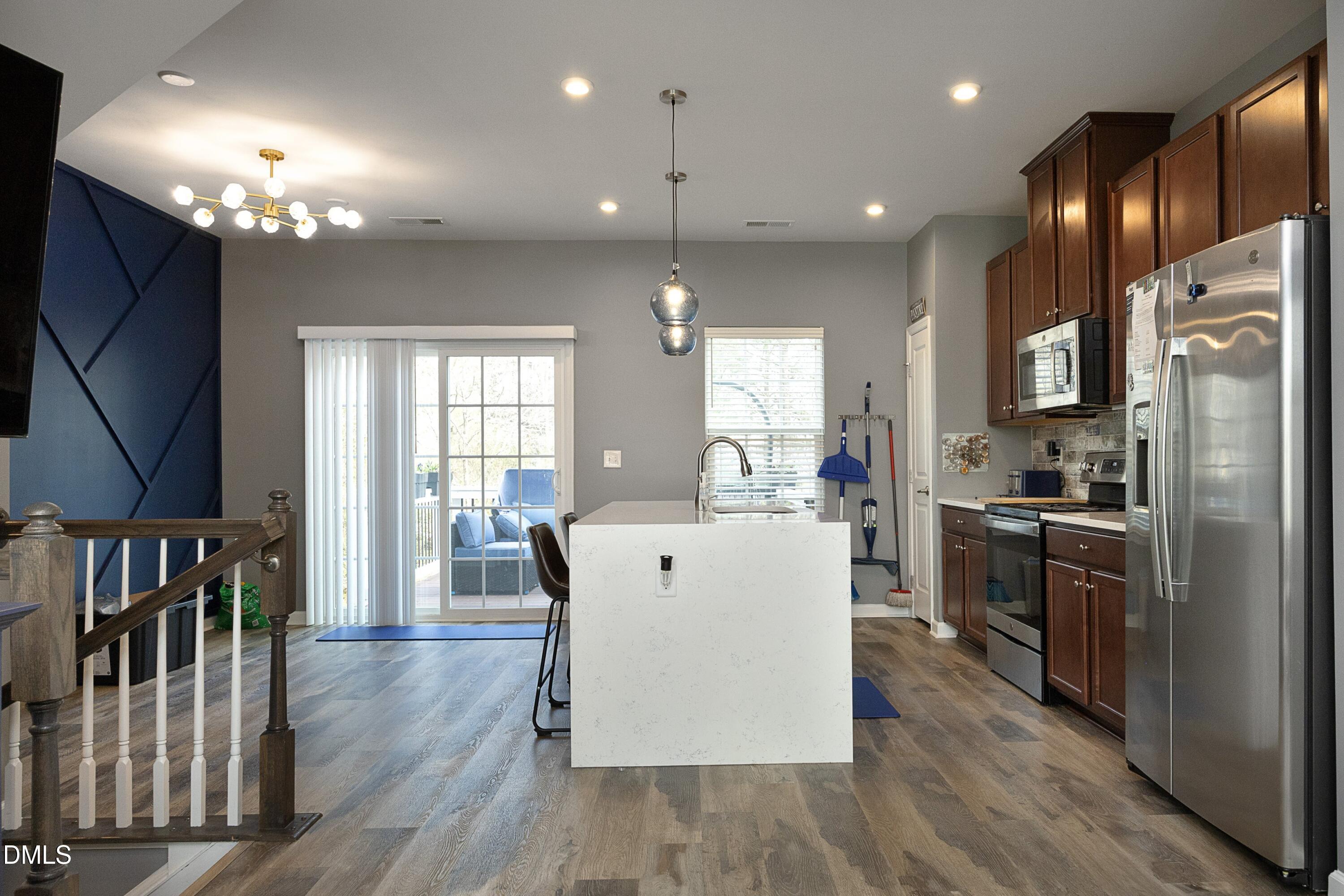 8716 Red Canyon Way Raleigh, NC 27616 - Photo 10 of 36 a large white kitchen with lots of counter space a sink appliances and cabinets