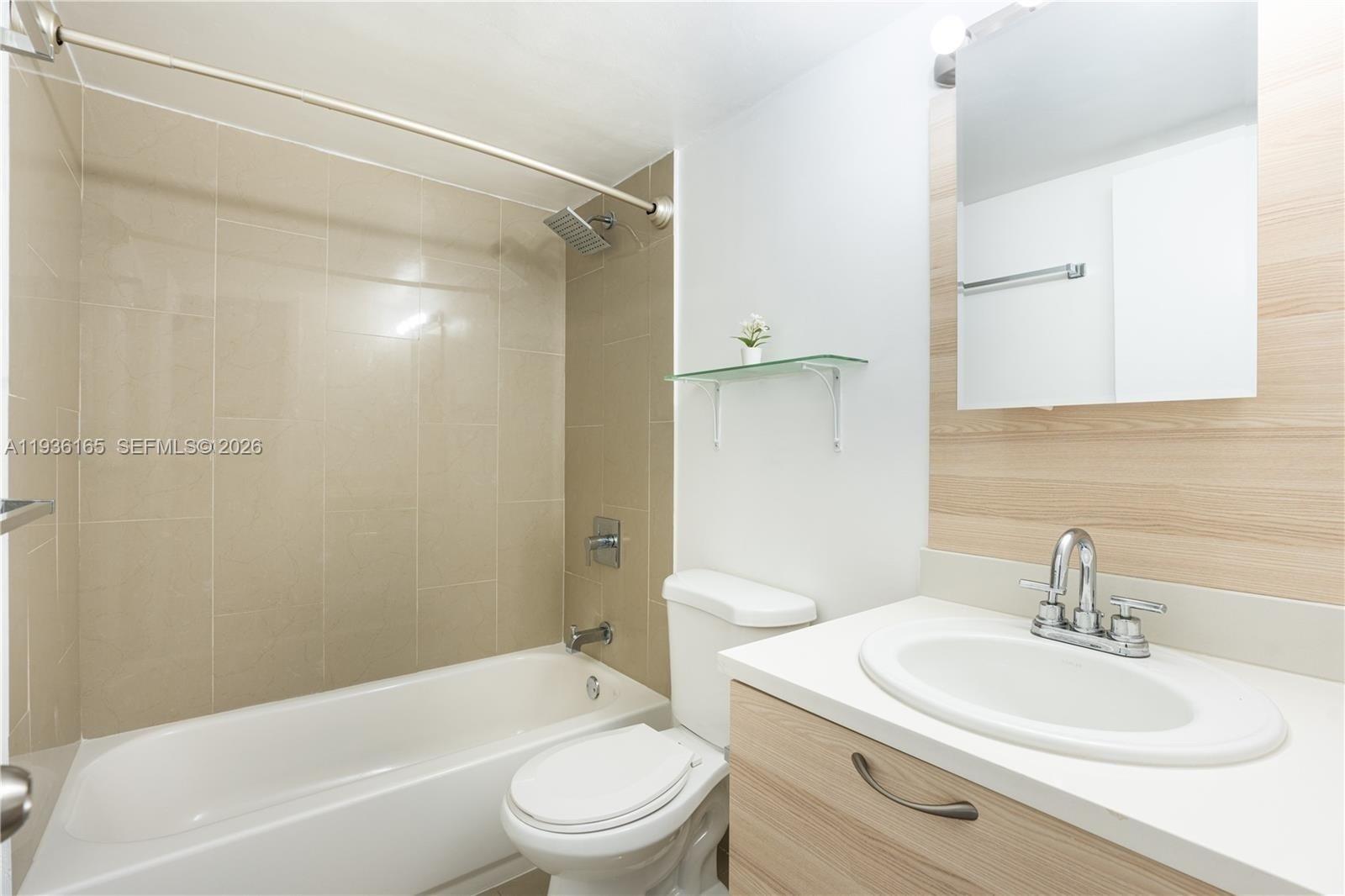 5501 Northwest 7th Street, Unit E302 Miami, FL 33126 - Photo 13 of 17 a bathroom with a sink toilet and shower