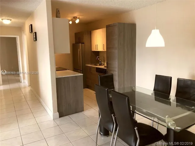 a view of a dining room with furniture and a window