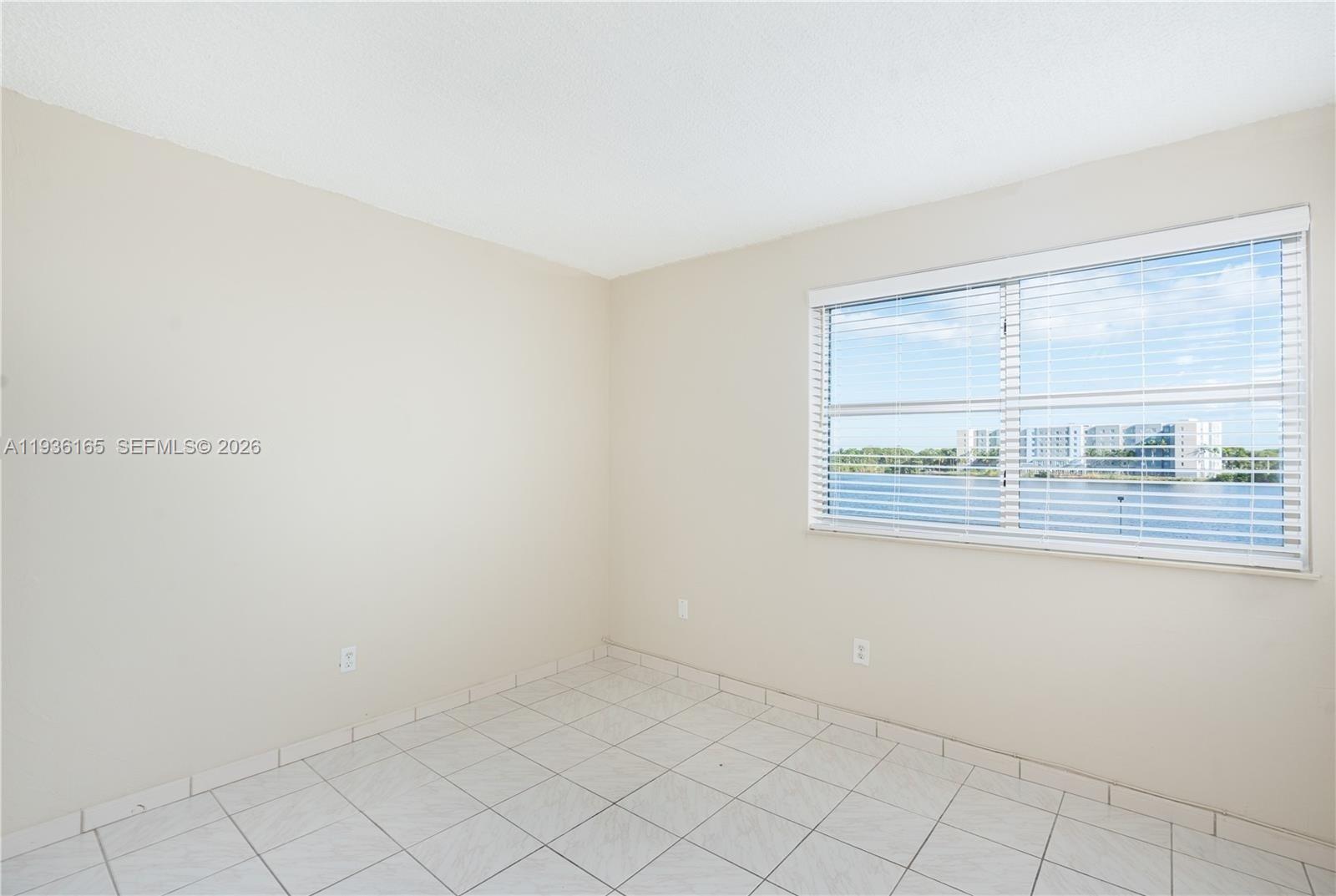 5501 Northwest 7th Street, Unit E302 Miami, FL 33126 - Photo 8 of 17 a view of an empty room with window