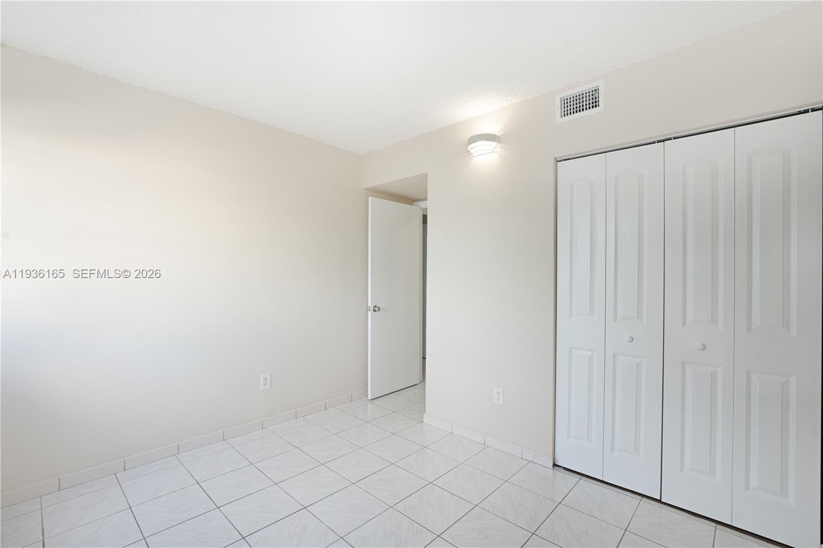 5501 Northwest 7th Street, Unit E302 Miami, FL 33126 - Photo 9 of 17 a view of an empty room
