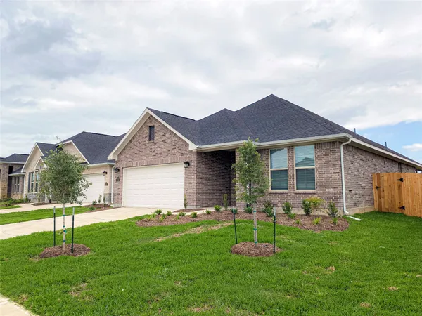 a front view of a house with a garden and yard