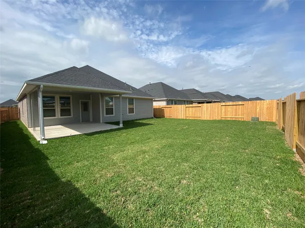 a view of a house with a garden and yard