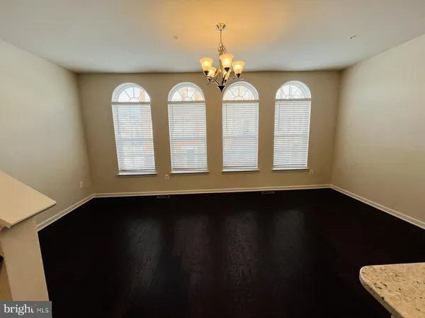 a view of a room with wooden floor and windows
