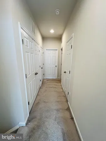 a view of a hallway with white walls