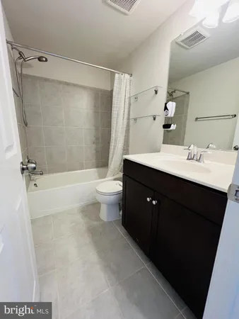 a bathroom with a bathtub a sink a toilet a mirror and shower