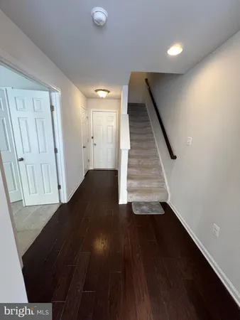 an entryway in a hall with wooden floor