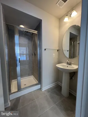 a bathroom with a sink a mirror and a shower