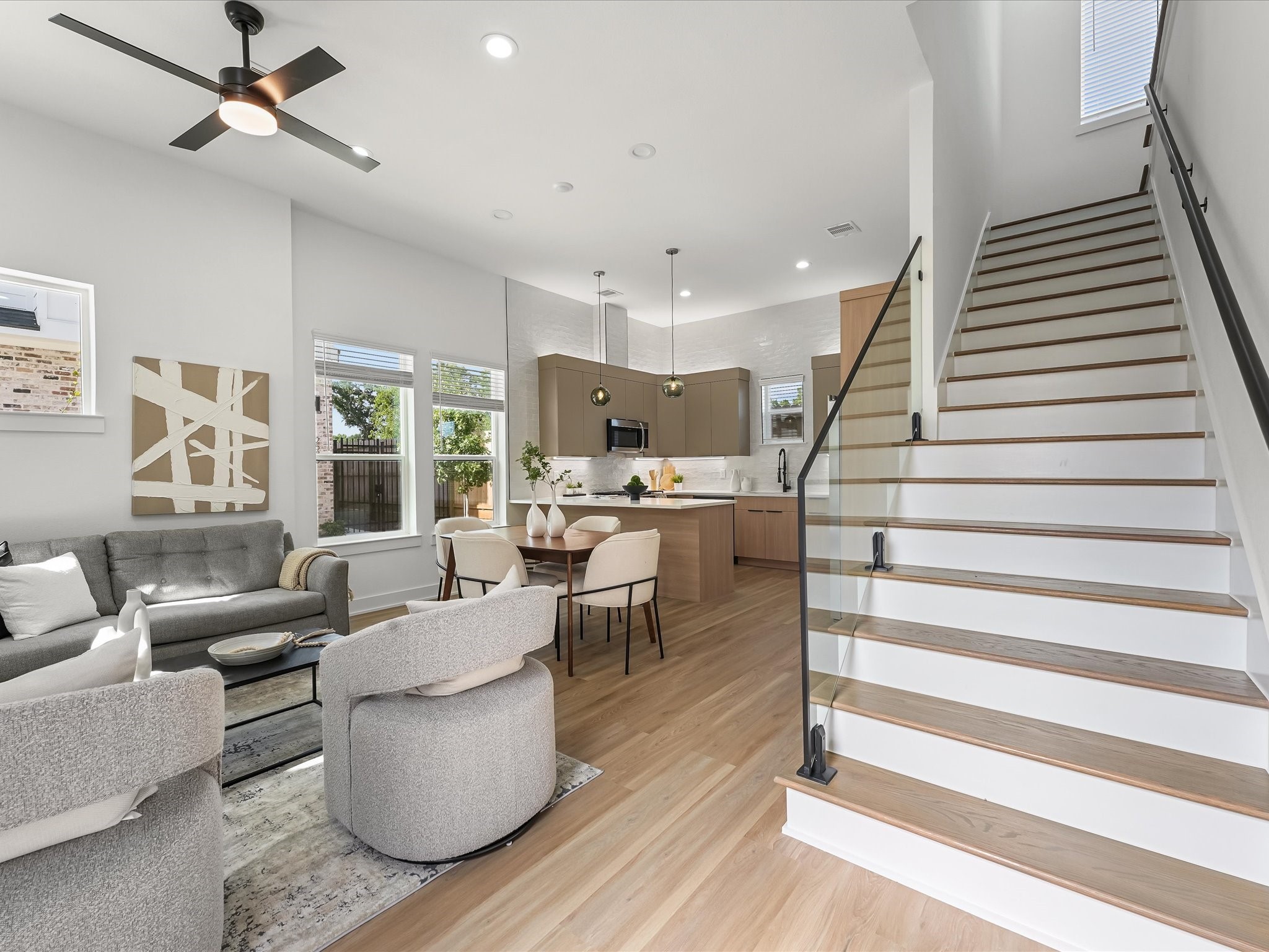 2598 West Tidwell Road Houston, TX 77091 - Photo 11 of 37 a living room with couches and kitchen view with wooden floor