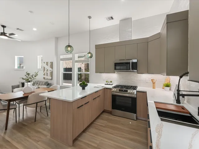 a kitchen with a sink stove and microwave
